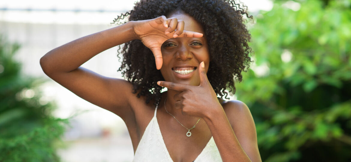 Smiling Black Woman Making Frame Gesture
